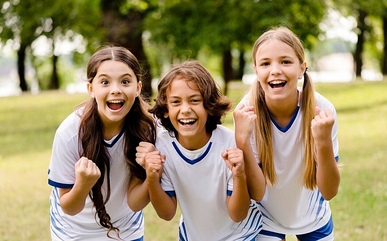 kids playing sports in the park
